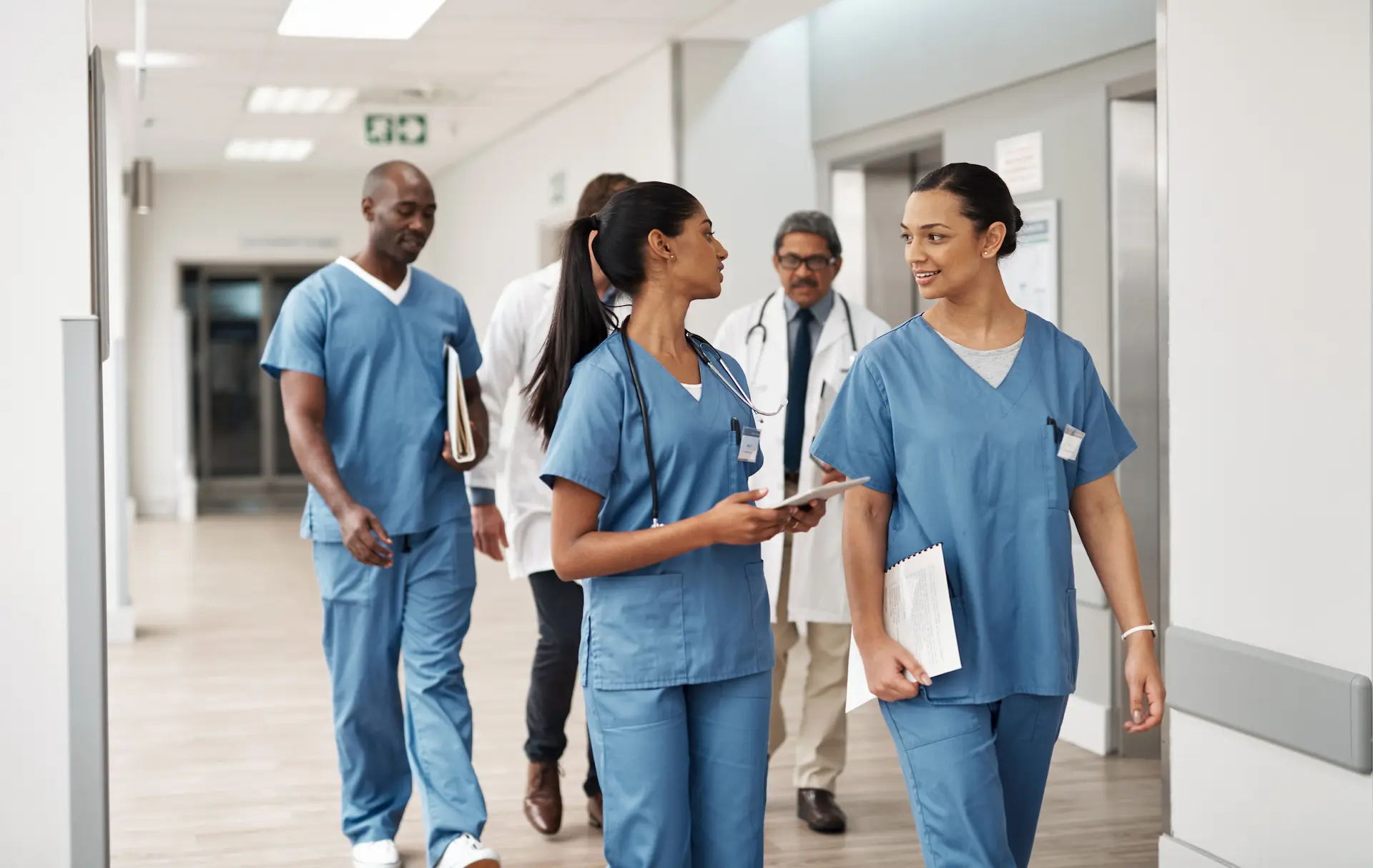 Doctor, nurse and walking hospital team after success surgery