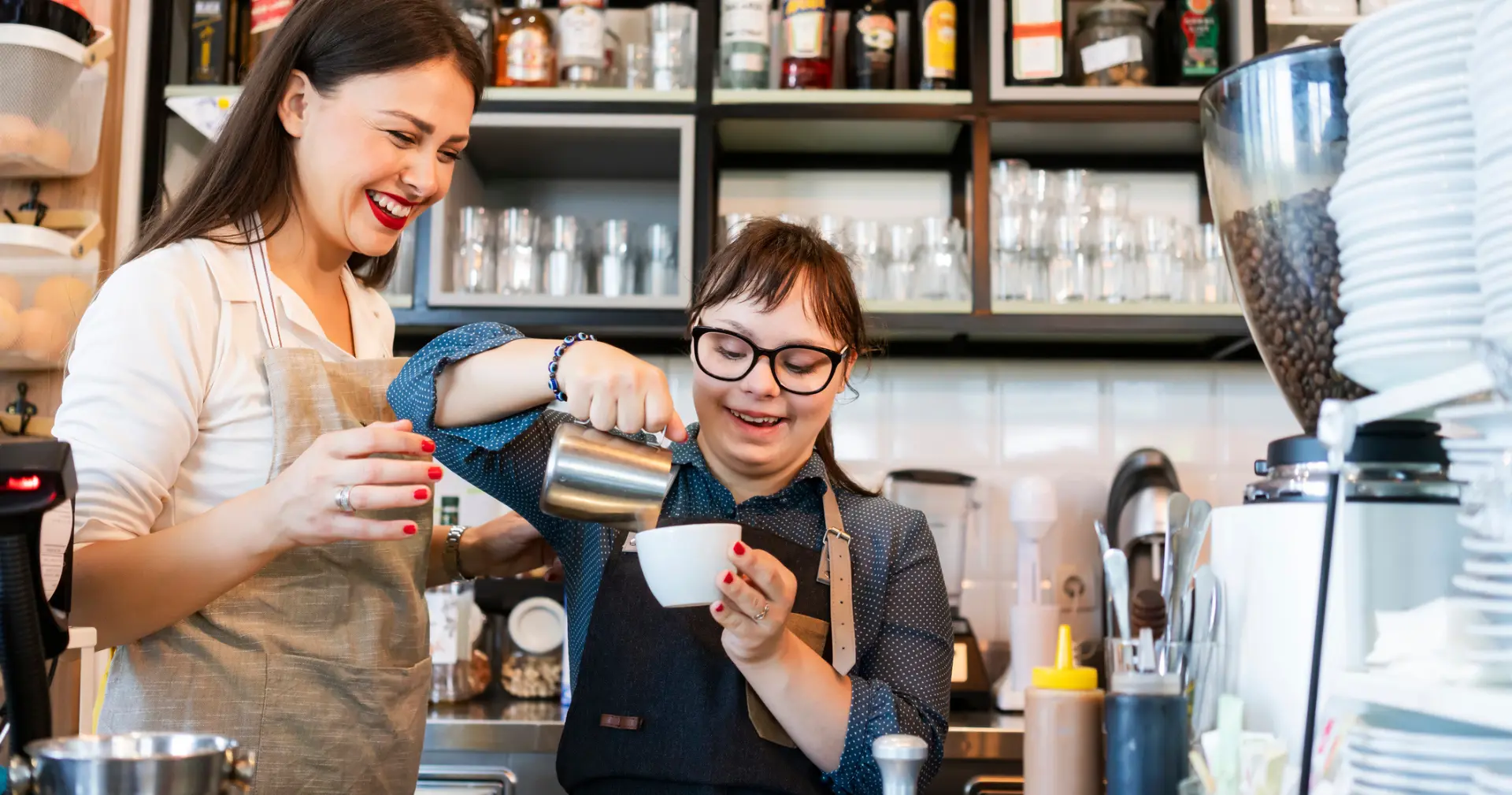 Young woman with Down Syndrome working at cafe preparing coffee